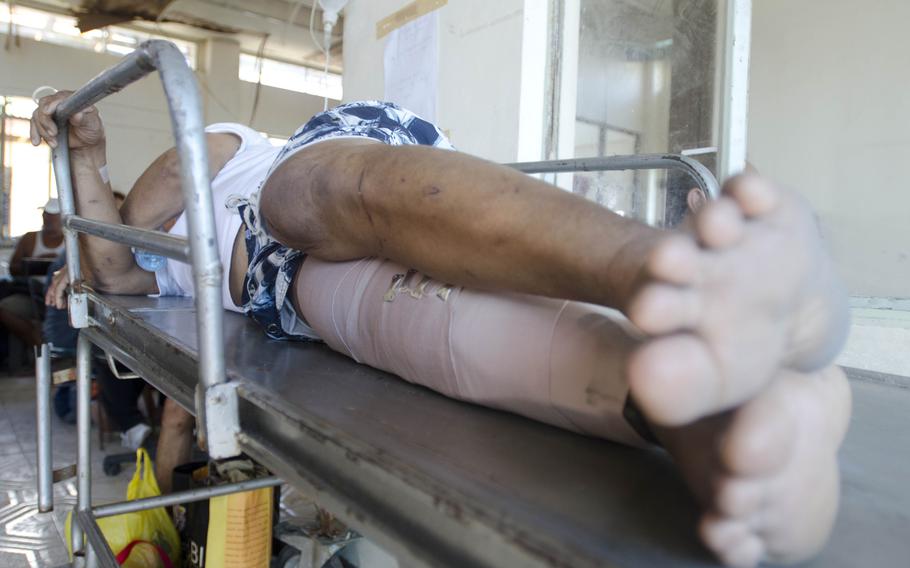 A patient sleeps on a stretcher after his surgery at the field hospital set up at Tacloban Airport, Tacloban, Philippines, Nov. 15, 2013. Eric Guzman/Stars and Stripes