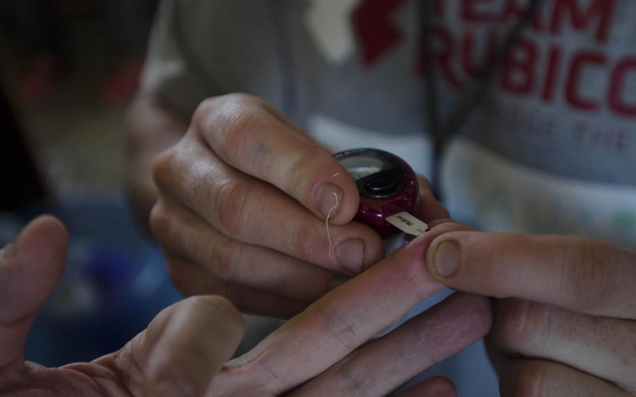 Breaux Burns, a paramedic and former active duty Marine, tests a patient's blood sugar levels at a field hospital in Tacloban, Philippines, Nov. 15, 2013. Eric Guzman/Stars and Stripes