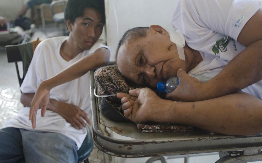 A patient awaits treatment for an injured leg at a field hospital in Tacloban, Philippines, Nov. 15, 2013. Eric Guzman/Stars and Stripes