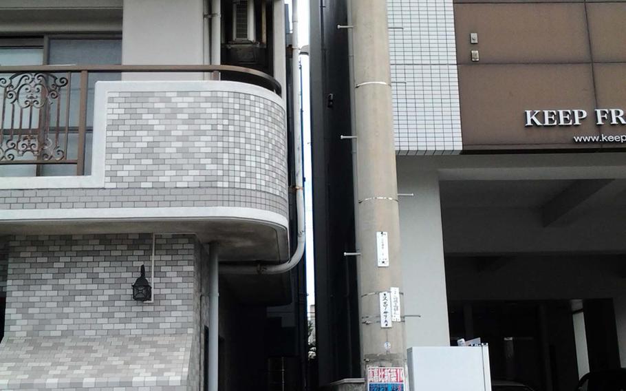Police tape marks the Naha alley where a Marine was found dead Thursday, Nov. 14, 2013.
