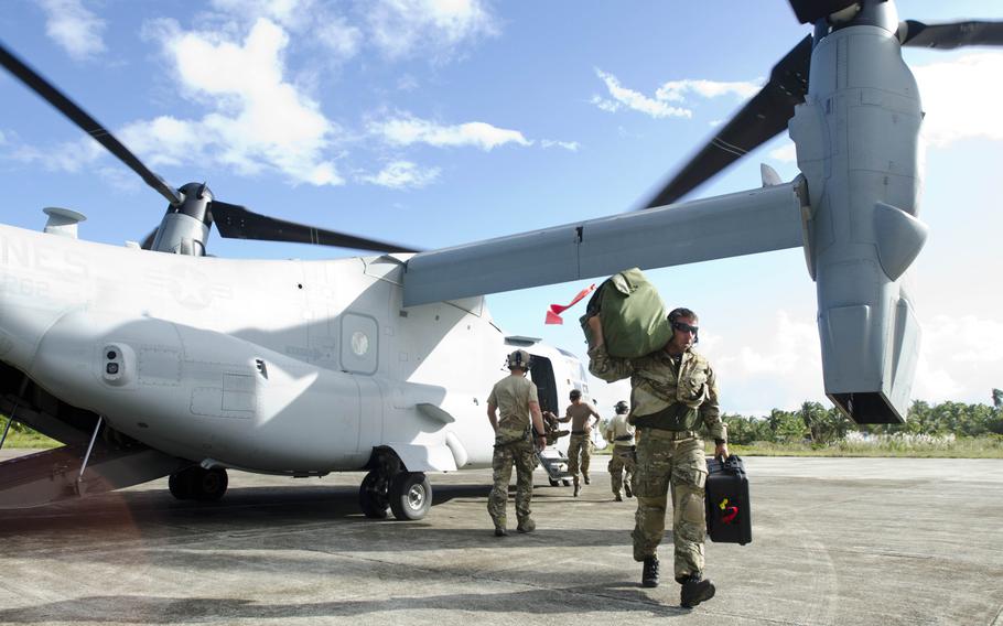 U.S. Army troops helping with the Super Typhoon Haiyan relief effort unload their gear from a V-22 Osprey after landing at an airstrip in Borongan, Philippines.