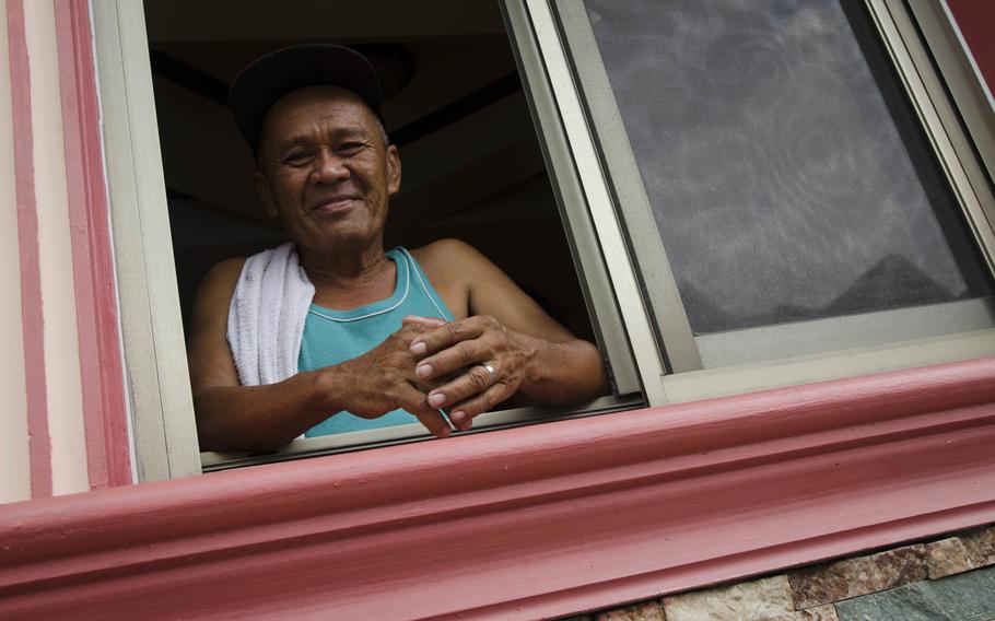 A victim of Super Typhoon Haiyain catches some fresh air at an apartment in Clark, Philippines provided by Mike and Regina Sculley.