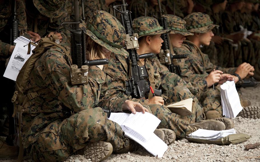 U.S. Marines receive anti-personnel mine instruction from their combat instructors on Oct. 11 at Camp Geiger, N.C. The Marine Corps is collecting data on the performance of female Marines when executing existing infantry tasks and training events for possible placement in jobs currently limited to males.