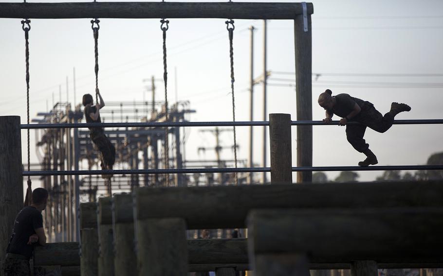 Female Marines navigate the obstacle course at Camp Geiger, N.C., on Oct 4. This is the first training company with female students as part of a collection of data on the performance of female Marines when executing infantry tasks and training events. The Marine Corps is soliciting entry-level female Marine volunteers to attend the eight-week basic infantryman and infantry rifleman training courses.