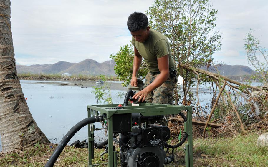 Lance Cpl. Zachary Badial from the 9th Engineer Support Battalion refuels a raw water pump near the Tacloban airport. U.S. Marines have purified more than 100 thousand gallons of ocean water for use by typhoon victims.