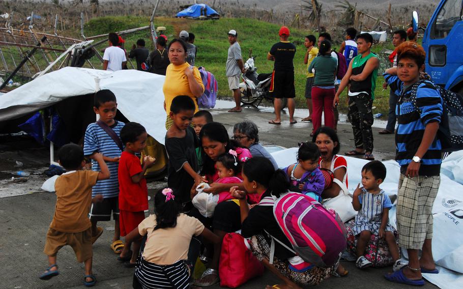 Young Filipino typhoon survivors wait for evacuation at Guiuan Airport in the Philippines on Nov. 22, 2013.