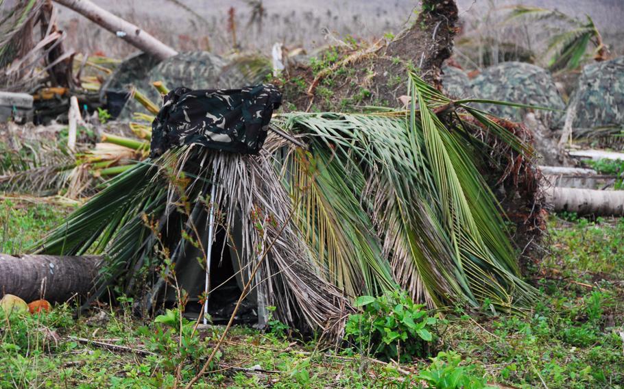 Filipino troops who replaced U.S. Marines at Guiuan Airport this week placed coconut fronds over their tents to help stay dry in monsoon rains.