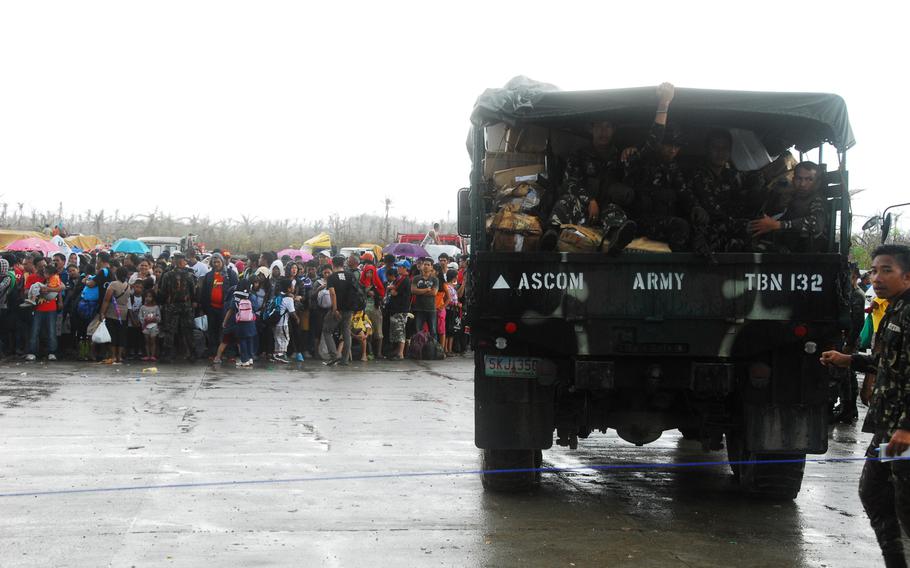 Filipino troops arrive to help control crowds at Guiuan Airport in the Philippines on Nov. 22, 2013.