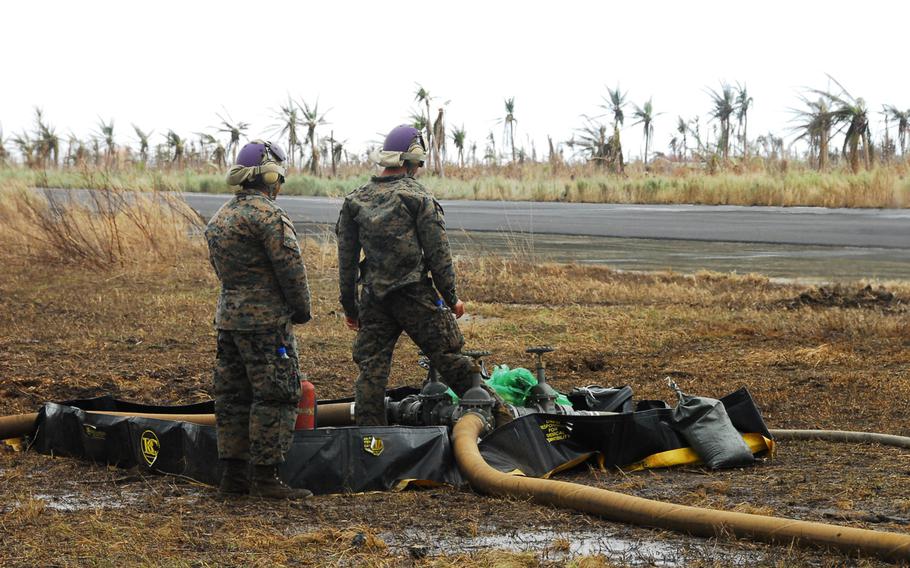 Marines pump the last drops of jet fuel out of a forward refueling point at Guiuan in the Philippines on Nov. 22, 2013.