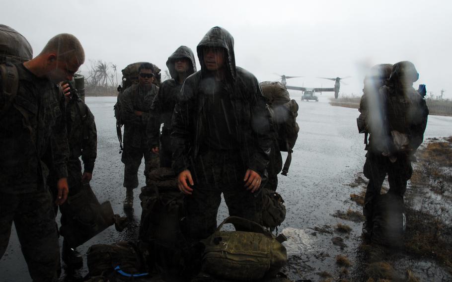 U.S. Marines wait in the rain at the Guiuan airport in the Philippines on Nov. 22, 2013. After more than a week on the ground helping Typhoon Haiyan victims, the Marines are packing up and heading back to Okinawa.