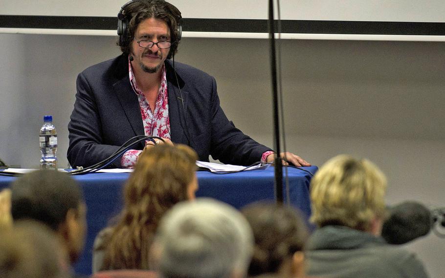 Host of "The Kitchen Cabinet" Jay Rayner asked the radio audience for on-air comments and posed questions to the panel of food experts, during a recording of the show Tuesday, Nov. 19, 2013, at RAF Lakenheath, England. The experts answered questions from the audience and talked about the differences between English and American cuisine.