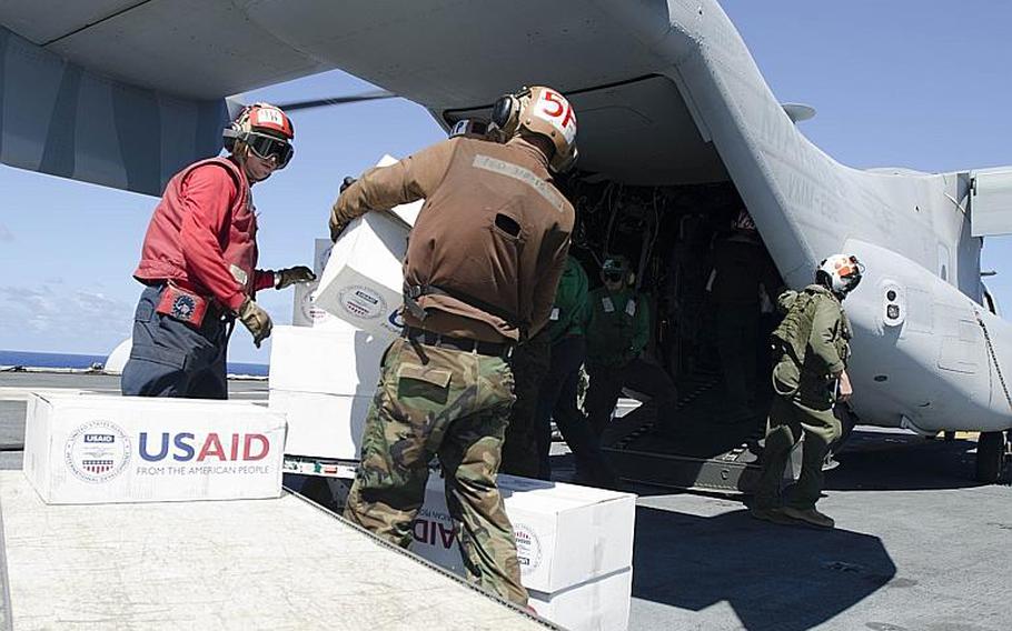 Sailors load relief supplies bound for the Philippines aboard a V-22 Osprey on the USS George Washington aircraft carrier last week.