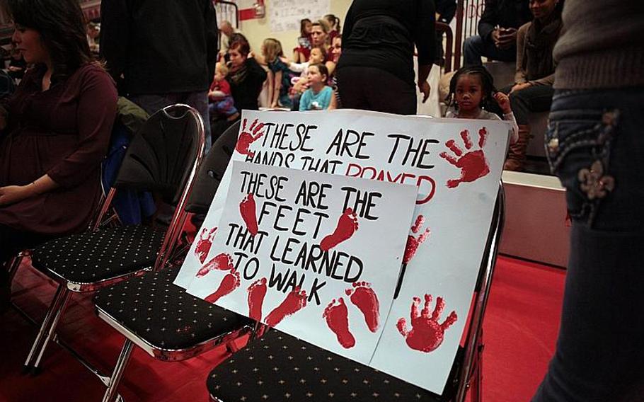 Welcome home signs sit in a chair as family members wait for the return of the 39th Transportation Battalion (Movement Control) from a nine-month deployment to Afghanistan.