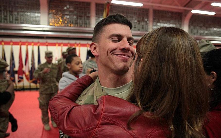 Capt. Nick Rehbaum of the 39th Transportation Battalion smiles as he holds his wife Alexis after a ceremony Saturday, Nov. 23, welcoming the unit home from nine months in Afghanistan.