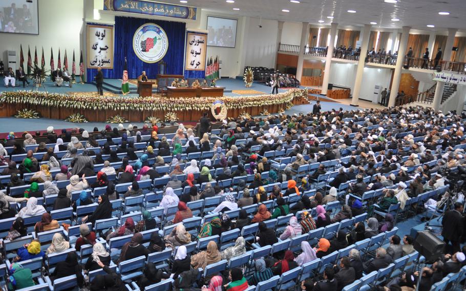 Delegates to the Loya Jirga, a gathering of Afghan leaders, discuss a proposed security agreement with the U.S. that would keep a military training and assistance force in Afghanistan past the end of 2014. The jirga approved the pact, which goes to parliament for approval and must ultimately be signed by Hamid Karzai, who has endorsed it. Heath Druzin/Stars and Stripes