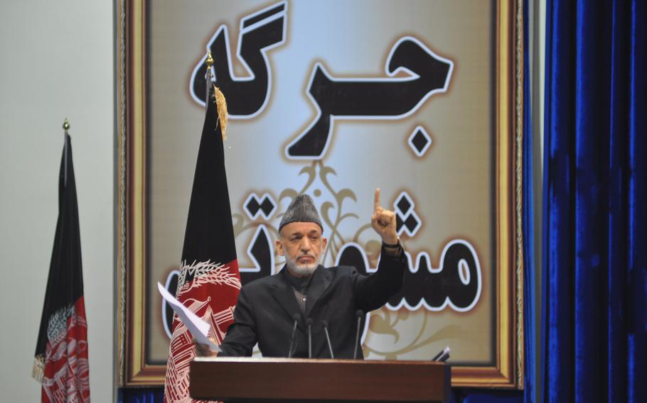 Afghan President Hamid Karzai addresses the Loya Jirga, a gathering of Afghan leaders that convened to discuss a proposed security agreement with the U.S. to keep a military training and assistance force in Afghanistan past the end of 2014. The jirga approved the pact, which goes to parliament for approval and must ultimately be signed by Karzai, who has endorsed it. Heath Druzin/Stars and Stripes