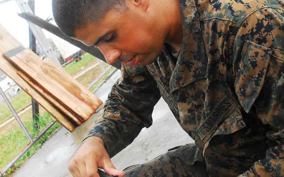 Marine Cpl. Heriberto Alonso, 25, of Rawley, N.C., eats coconut during typhoon relief operations in The Philippines on Friday, Nov. 22, 2013.