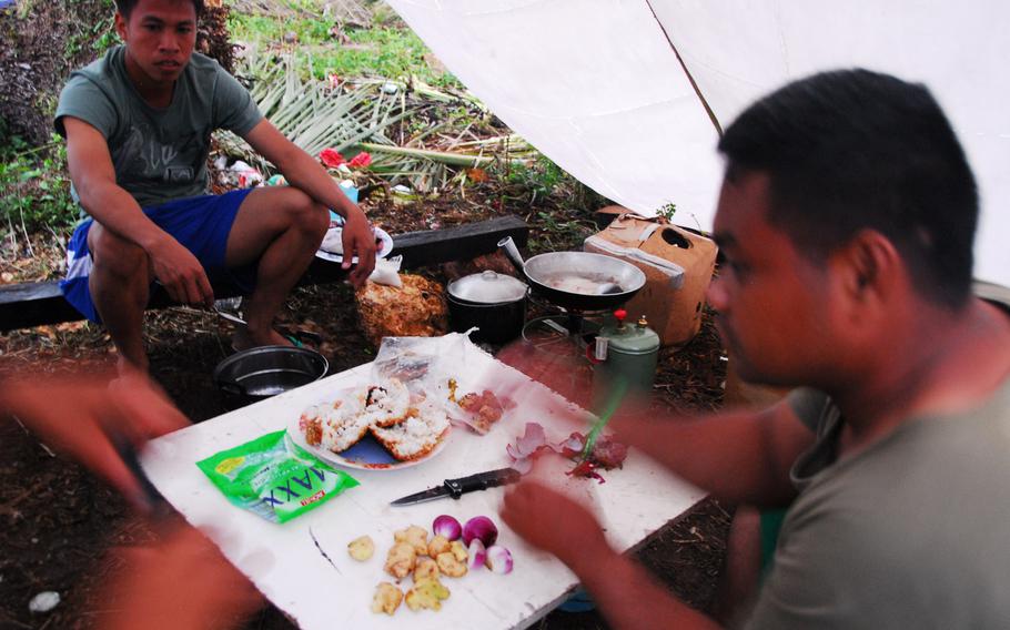 Filipino airmen prepare pork adobo during typhoon relief operations in The Philippines on Thursday, Nov. 21, 2013.