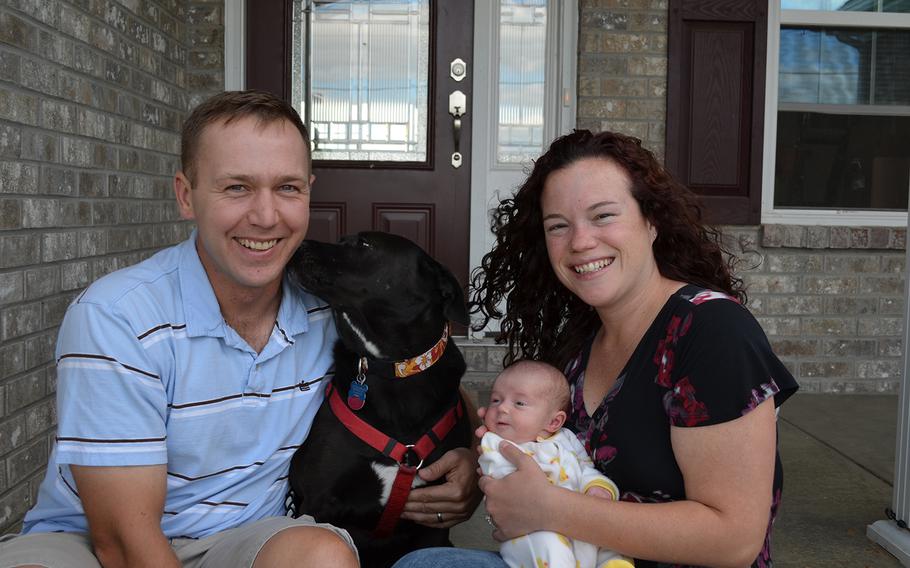 Marc and Sallie Bailey pose with daughter Violet Ann (and their pet dog Maggie) in early September. Violet was born Aug. 30.