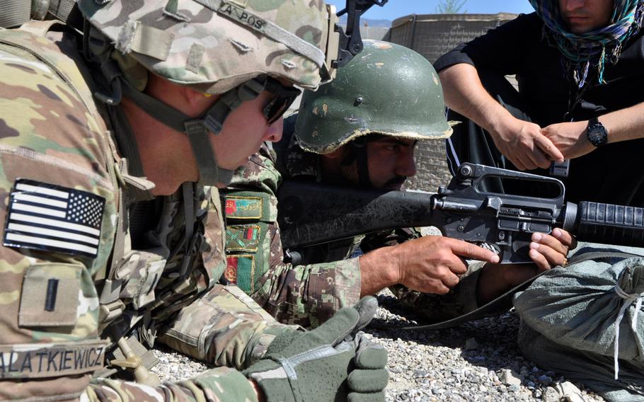 The decision by Afghanistan???s Loya Jirga council to allow foreign advisers to remain in the country after 2014 means that several thousand U.S. and NATO instructors will likely continue to train Afghan forces. In this photo, an adviser, Lt. Jon Walatkiewicz, works with Afghan National Army troops at Forward Operating Base Joyce in eastern Afghanistan.