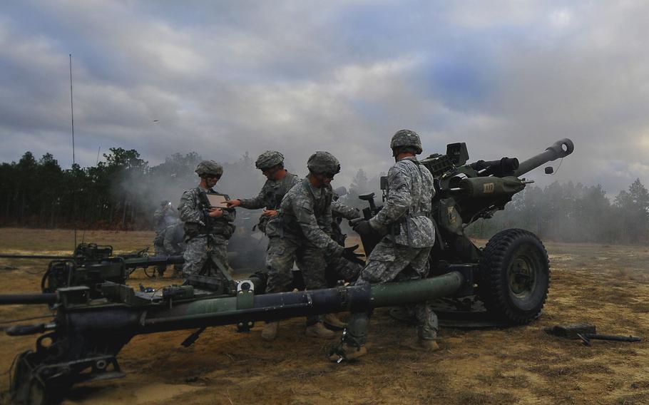Paratroopers from the 319th Airborne Field Artillery Regiment, 2nd Brigade Combat Team, 82nd Airborne Division, fire newly fielded M119A3 howitzers on Nov. 22, 2013, at Fort Bragg, N.C.