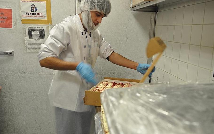 Harees, a local contractor, unwraps a pallet of cakes. Altogether, the U.S. military shipped out 20,000 pies and 1,700 gallons of eggnog, plus, of course, 70,000 pounds of turkey for the holiday. Chief Warrant Officer II Joshua Johnston, a theater food adviser, said about 6.6 pounds of Thanksgiving food were allocated per service member in Afghanistan. 