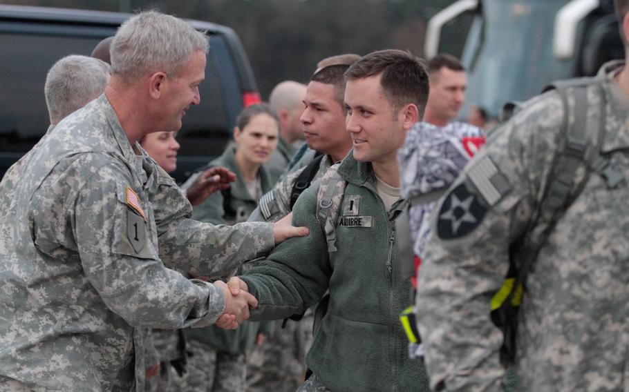 Maj. Gen. Richard Longo, left, deputy commander of U.S. Army Europe, shakes the hands of soldiers from the 5th Battalion, 7th Air Defense Artillery Regiment, Monday, Dec. 2, 2013, before they board a plane for Turkey. About 250 soldiers from the unit are expected to spend a year manning Patriot missile batteries in defense of Turkey, which fears the possibility of missile strikes from Syria, a country consumed by a bloody civil war.