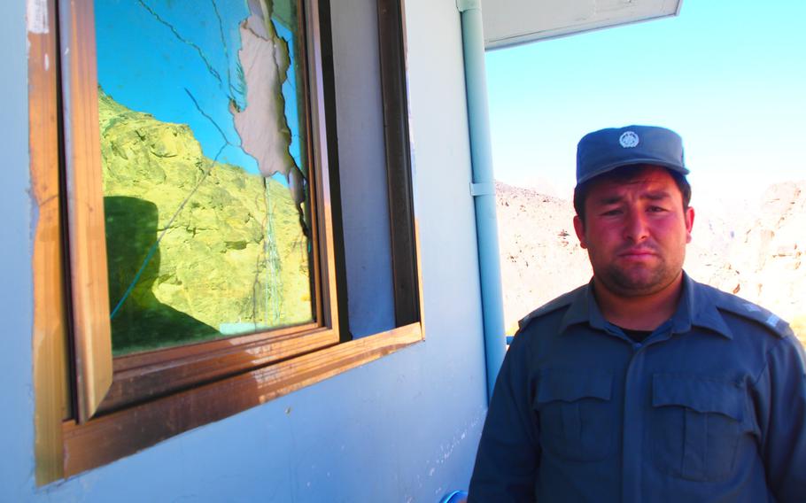 Mirza Hussein, the deputy police chief for Shibar district, a volatile region in Bamyan province, Afghanistan, stands next to a window of his police station smashed by a rocket-propelled grenade. Violence has been rising in parts of the normally quiet province since international troops pulled out in April.