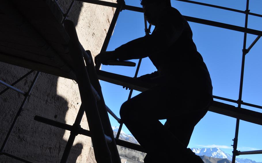 Mohammad Isaq Azizi, head of Bamiyan province???s Culture and Tourism Department, walks up the scaffolding of the largest of the famed Bamiyan Buddhas. The Buddhas were dynamited by the Taliban in 2001 and both local officials and international organizations have been puzzling over what to do with the remains ever since.
