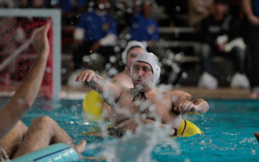 Pfc. Michael Fiorilli of Wheeling, W. Va., passes the ball during a wounded warrior water polo tournament Thursday, Dec. 12, 2013 in Baumholder, Germany.