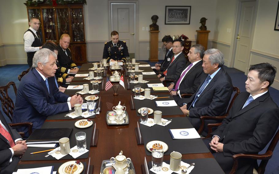 U.S. Defense Secretary Chuck Hagel, left, meets with Singapore's Defense Minister Dr. Ng Eng Hen at the Pentagon, Dec. 12, 2013.