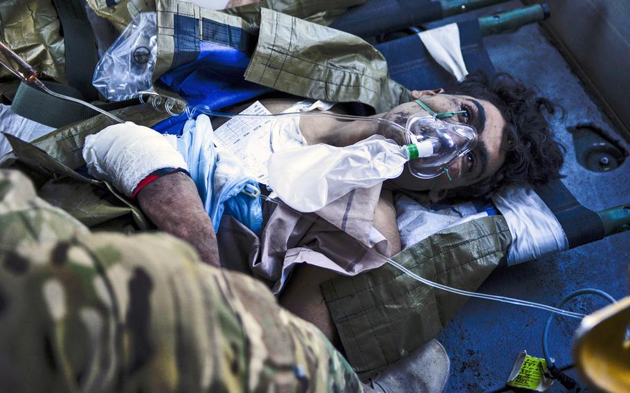 A wounded Afghan soldier is loaded onto a UH-60 Black Hawk medevac bird, Oct. 22, 2013, at Forward Operating Base Azizullah.