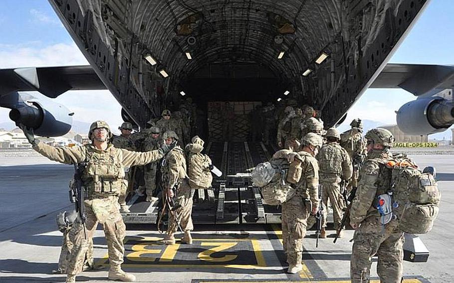 Sgt. 1st Class Frank Limtiaco, left, celebrates the departure from Afghanistan for 1st Battalion, 294th Infantry Regiment, Guam Army National Guard. Limtiaco is one of nearly 150 soldiers who left North Kaia, Kabul, Afghanistan, Dec. 28, representing the last of Guam's nearly 600 troops in Afghansitan.