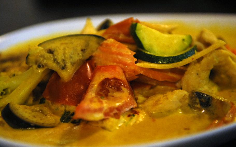 A plethora of vegetables, including egg plant, tomato, mushroom, broccoli, carrot, lemon grass and bamboo shoots, add texture and flavor to chicken curry at Zimtblüte restaurant in Einsiedlerhof, Germany.