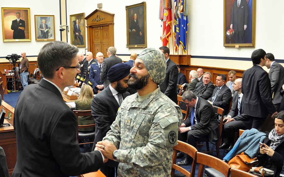 Army Reserve Maj. Kamal S. Kalsi speaks with U.S. Rep. Joe Heck, R-Nev., before the start of a hearing on a new Defense Department directive that provides guidance on uniforms and grooming with respect to religious beliefs at a House Armed Services Committee personnel subcommittee on Capitol Hill on Wednesday, Jan. 29, 2014.