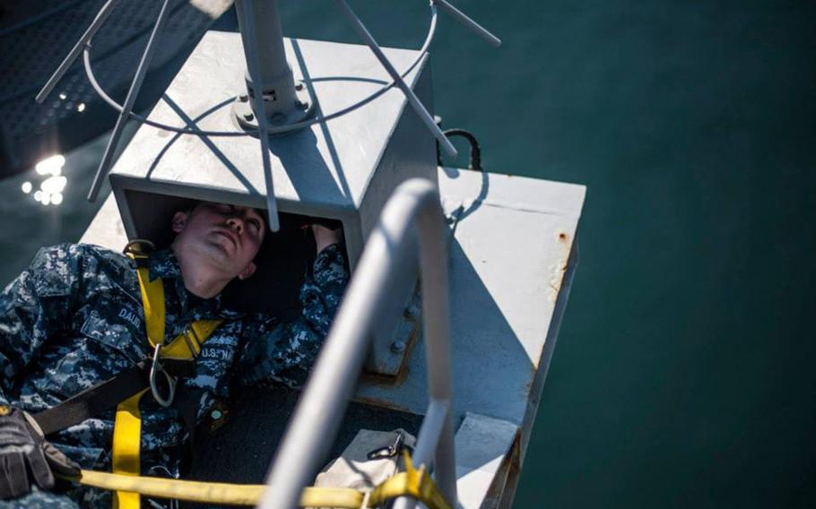 Petty Officer 2nd Class David Daub weatherizes an antenna cable on a catwalk on the USS George Washington at Yokosuka Naval Base, Japan, on Jan. 31, 2014. According to the Navy's personnel chief, the service will make some changes to its advancement system for petty officers.