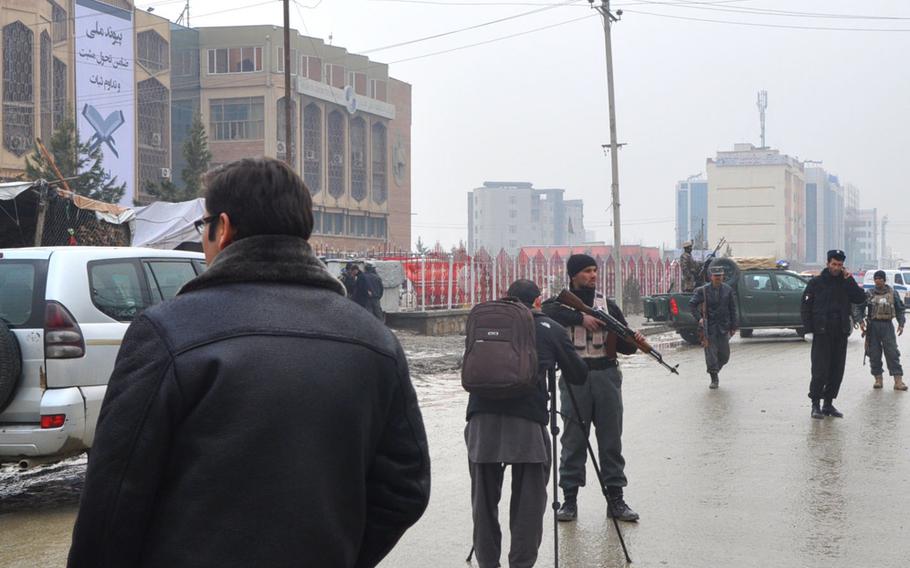 Following a suicide attack on a cultural center and library in Kabul on Thursday, Feb. 20, 2014, Afghan police guarded the road and kept reporters at a distance. Officials said the bomber detonated himself outside the cultural center around 9:30 am.
Cid Standifer/Stars and Stripes