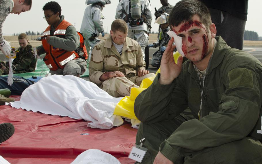 An airman from the 374th Airlift waits in triage to have his simulated injuries assessed during the Samurai Readiness Inspection at Yokota Air Base on March 3, 2014.