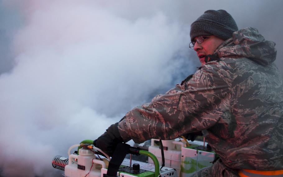 An airman from the 374th Airlift Wing Inspection Team operates a fog machine in preparation for a simulted Vehicle Borne Improvised Explosive Device during the Samurai Readiness Inspection at Yokota Air Base on March 4, 2014.