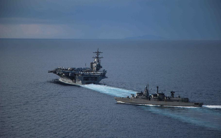 The aircraft carrier USS George Bush conducts an exercise with the Hellenic Navy frigate HS Elli in the Mediterranean Sea after its first port visit in Greece March 7, 2014.