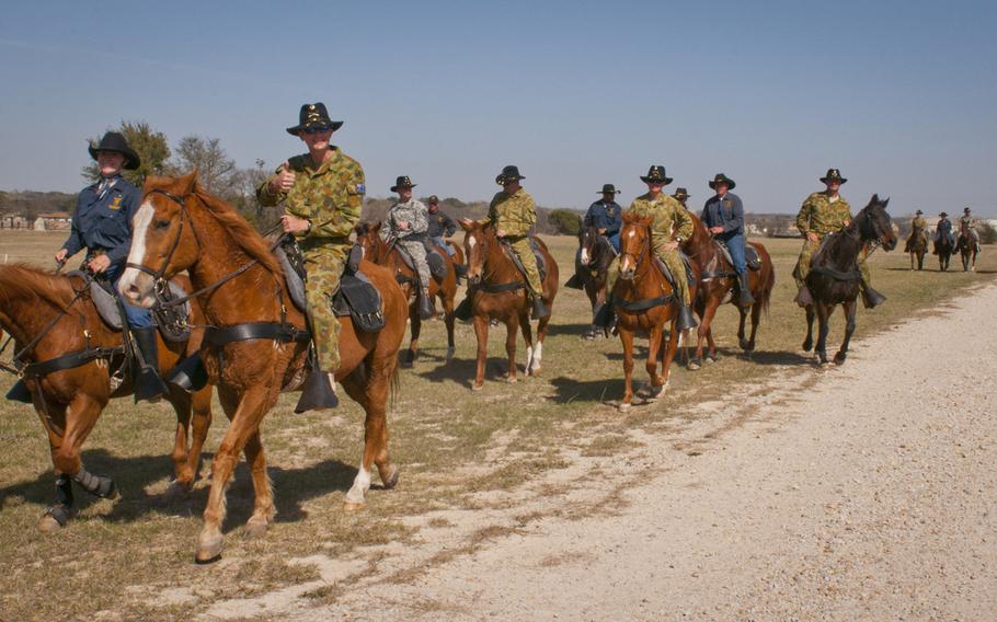 Australian army soldiers take a ride with members of the 1st Cavalry Division command staff and the 1st Cavalry Division Horse Cavalry Detachment on March 20, 2014. As the U.S. is looking to trim the number of troops serving in the military, the Austrailian Defence Force is recruiting U.S. servicemembers join its ranks. Many troops, especially enlisted servicemembers, stand to make more money in the Australian military.