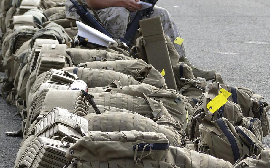 Lance Cpl. Claudio Ibarra writes down the serial number on a rifle Tuesday morning as he prepares to leave Camp Pendleton, Calif. for a deployment to Australia as part of 1st Battalion, 5th Marine Regiment.