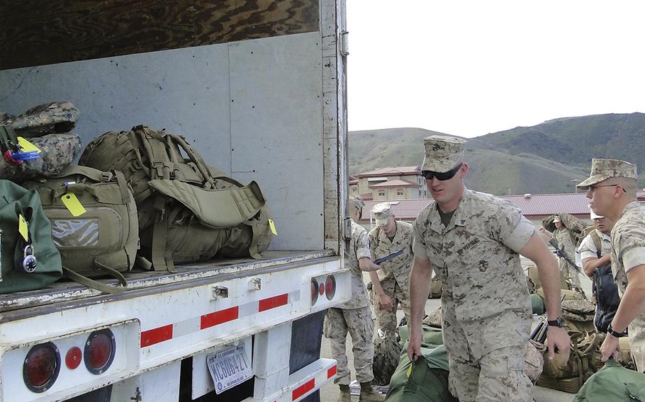 Marines load their bags onto trucks Monday morning at Camp Pendleton, Calif., as they prepare to leave for a six-month deployment to Australia. First Battalion, 5th Marine Regiment is the first battalion-sized unit to deploy to Australia, and will be joined in the Northern Territory by a small Hawaii-based aviation element.