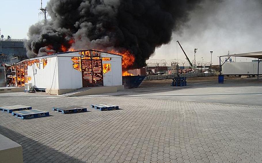 Flames take over a 300-square-foot Navy Exchange storage building in Jebel Ali, Dubai, Wednesday, April 2, 2014. The cause of the fire is under investigation.