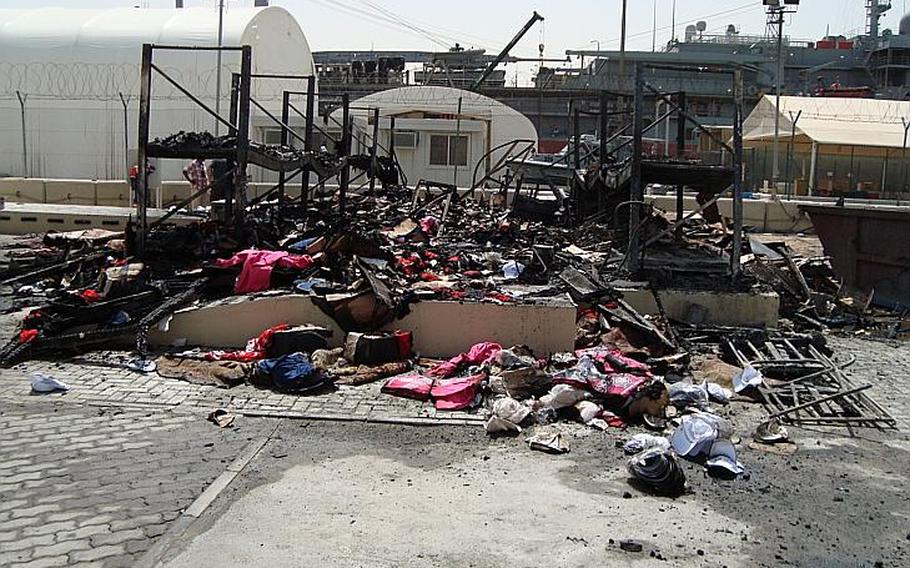 A small Navy Exchange warehouse building in Jebel Ali, Dubai, lies in ruins after a fire Wednesday, April 2, 2014. Officials said the fire would have little effect on distribution.