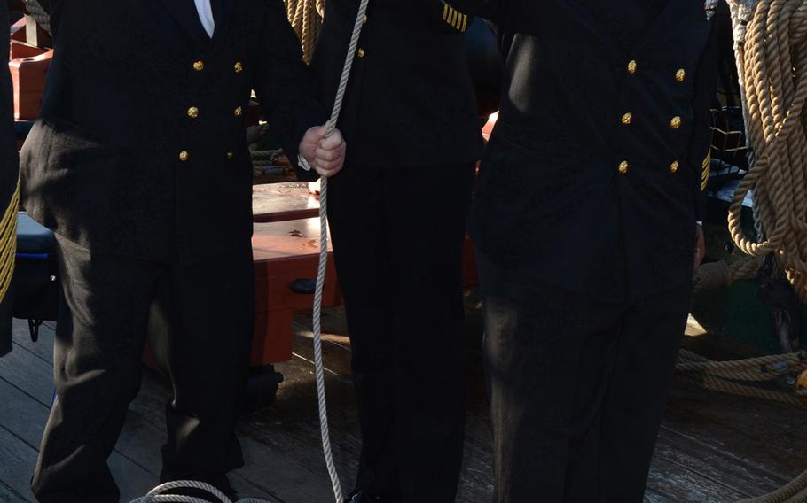 Retired Chief Petty Officer James Drown, left, assists USS Constitution Command Senior Chief Nancy Estrada and Chief Navy Counselor Louie Beasley with hoisting the American flag during morning colors aboard Old Ironsides in Charlestown, Mass. Drown, a 90-year-old World War II veteran, was the USS Constitution's guest of honor for the command's celebration of the 121st birthday of the Navy chief petty officer rank.