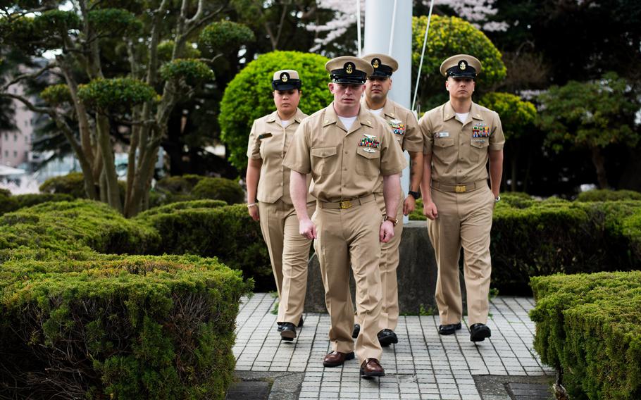 Chief petty officers perform morning colors at Fleet Activities Yokosuka, Japan, on April 1, 2014. Chiefs from different Yokouska commands participated to commemorate the 121st birthday of the U.S. Navy chief petty officer.