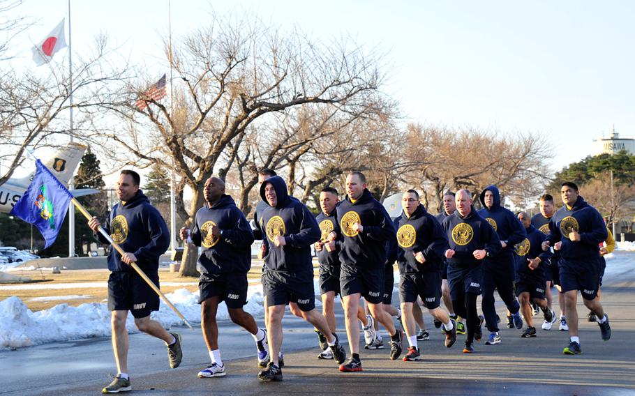 Chief petty officers assigned to Naval Air Facility Misawa, Japan, conduct an early-morning pride run in honor of the 121st birthday of the chief petty officer rank on April 1, 2014.