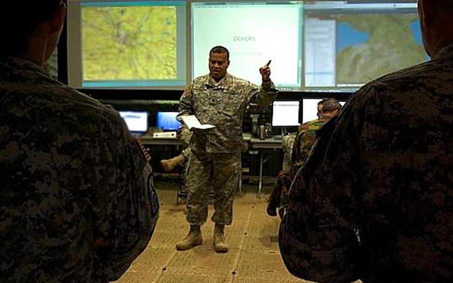 Lt. Col. Nat Edwards, U.S. Army Europe's Contingency Command Post deputy chief of operations, briefs staff March 26, 2014, at Novo Selo Training Area, Bulgaria. Roughly 700 personnel from 13 countries are at Novo Selo taking part in Saber Guardian 2014, a humanitarian aid and peace support exercise in the Black Sea region.