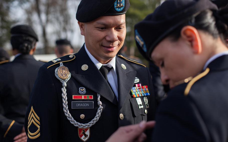 Sgt. 1st Class Geriberto Dragon Jr. corrects a deficiency on a soldier's service uniform during an in-ranks inspection Thursday, April 3, 2014, at Panzer Kaserne. 